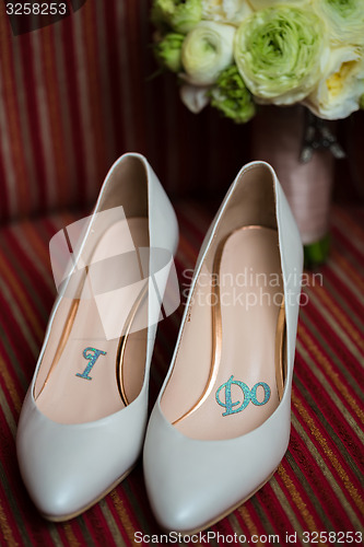 Image of wedding shoes and bouquet 