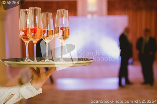 Image of Waiter serving champagne on a tray