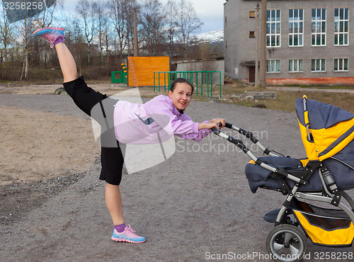 Image of young woman is engaged in aerobics in a stadium