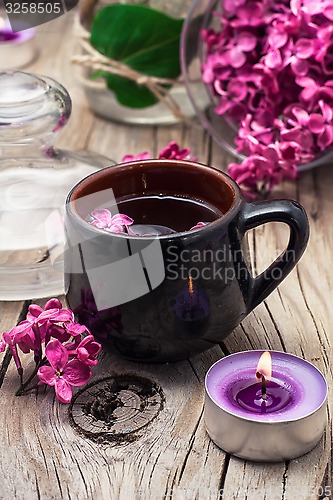 Image of fragrant tea and a branch of lilac