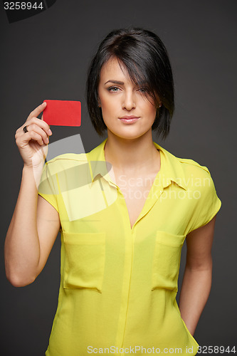 Image of Confident woman showing blank credit card