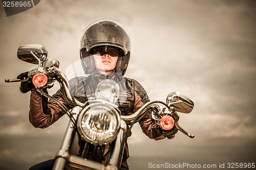 Image of Biker girl on a motorcycle