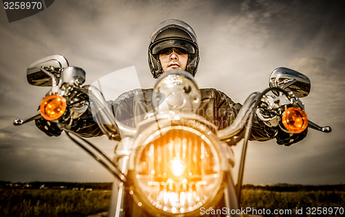 Image of Biker racing on the road