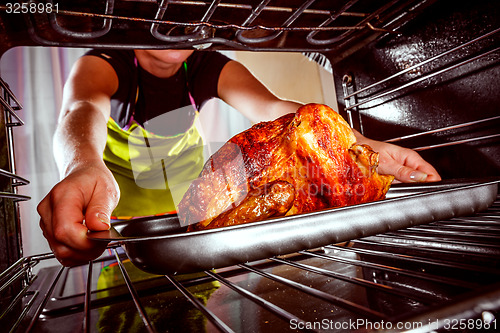 Image of Cooking chicken in the oven at home.