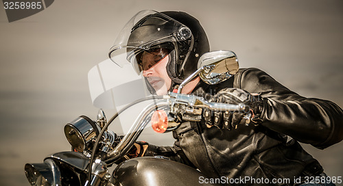 Image of Biker racing on the road