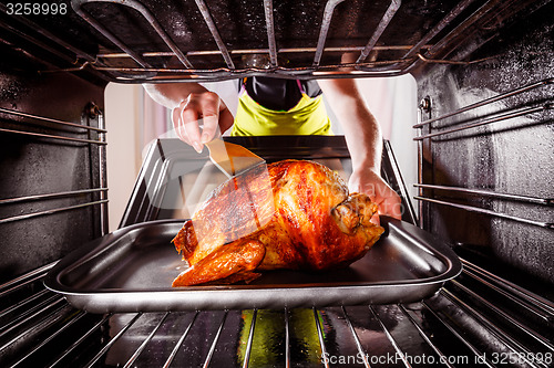 Image of Cooking chicken in the oven at home.