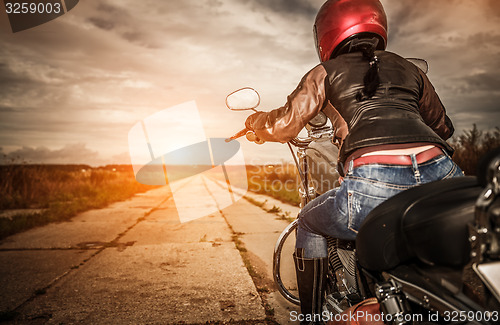 Image of Biker girl on a motorcycle