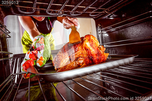 Image of Cooking chicken in the oven at home.