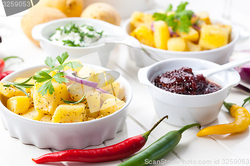 Image of Baked potatoes with chutney and sour cream