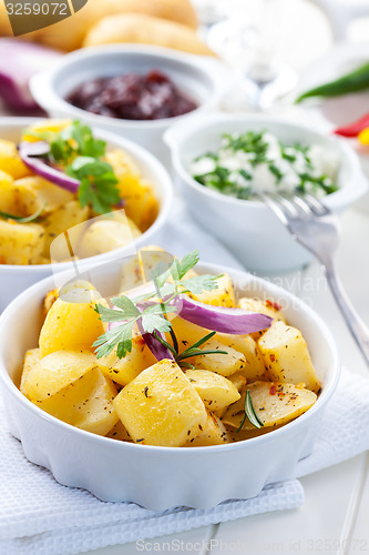 Image of Baked potatoes with chutney and sour cream