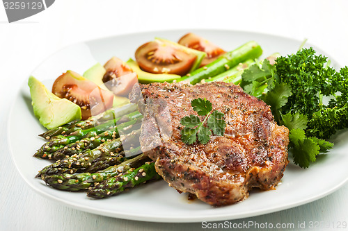 Image of Glazed green asparagus with grilled pork chop