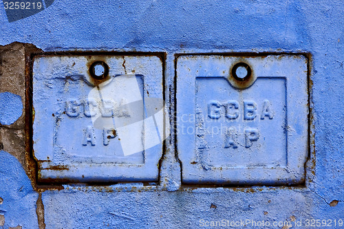 Image of two metal box and a blue broken wall