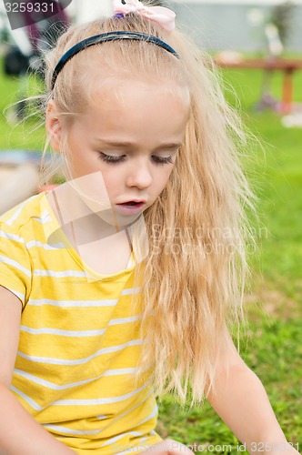 Image of Portrait of beautiful playing little girl