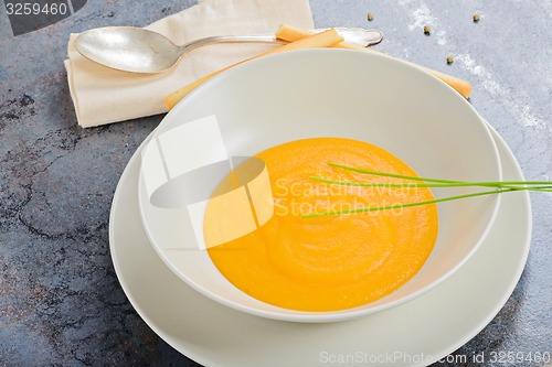 Image of Pumpkin creamy soup with spoon and napkin