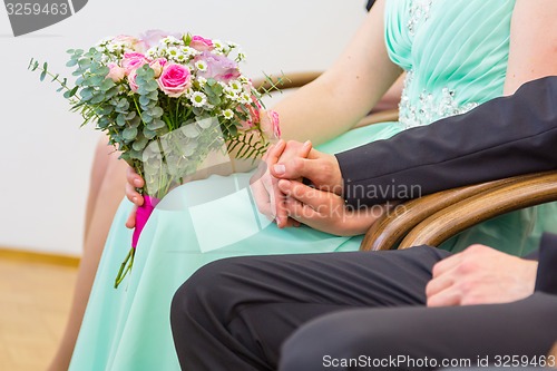Image of Wedding couple holding hands.