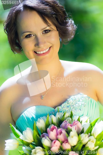 Image of Happy bride with wedding bouquet.