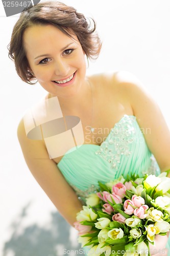 Image of Happy bride with wedding bouquet.