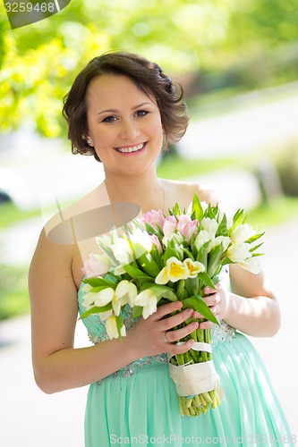 Image of Happy bride with wedding bouquet.