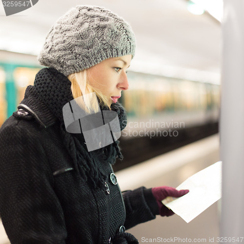 Image of Lady looking on public transport map panel.