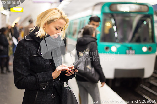 Image of Woman on a subway station.