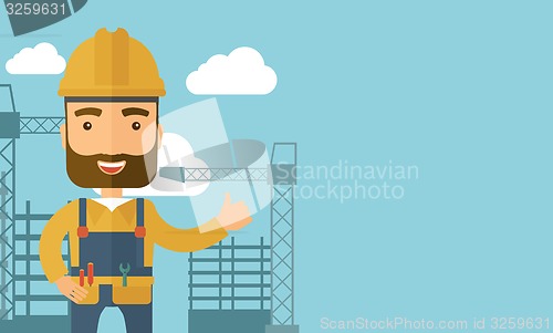 Image of Man standing infront of construction crane tower.