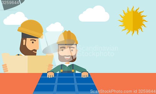 Image of Man putting a solar panel on the roof.