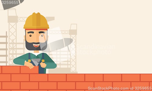 Image of Builder man is building a brick wall.