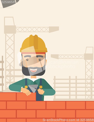 Image of Builder man is building a brick wall.