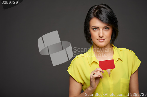 Image of Confident woman showing blank credit card