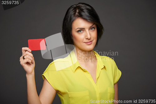 Image of Confident woman showing blank credit card