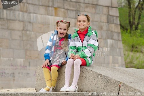 Image of Two girls sit on a granite staircase