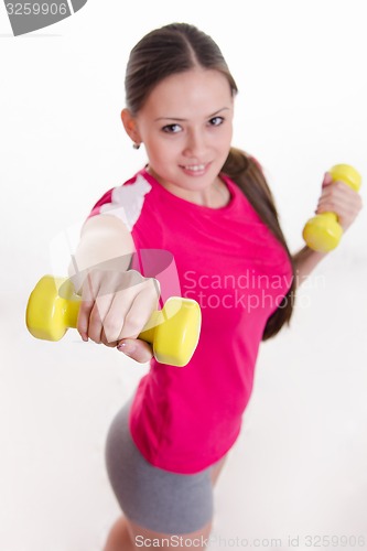 Image of Dumbbells in the hands of athletes