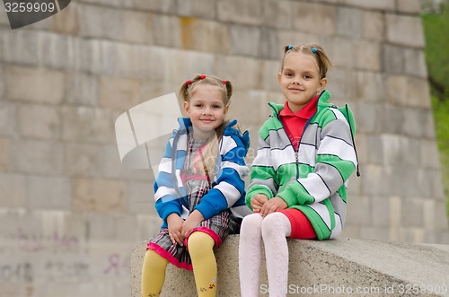 Image of Sisters sitting on a granite ramp