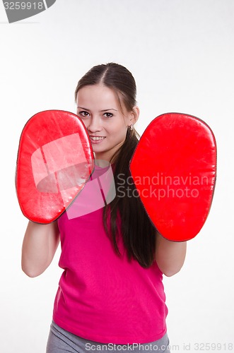 Image of Athlete with boxing paws in the hands of