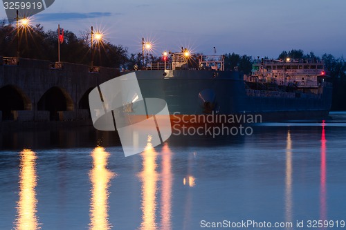 Image of moored ship to the pier at sunset