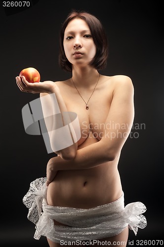 Image of Nude pretty woman with apple