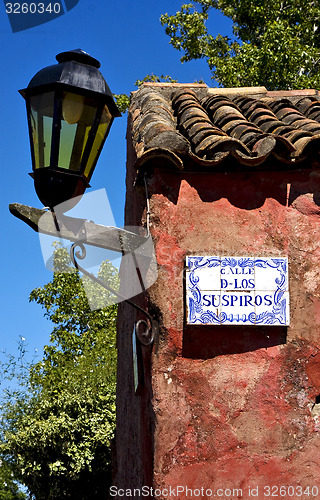 Image of street lamp and plate  in calle de los suspiros  uruguay