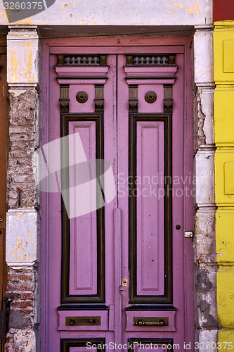 Image of black violet wood old door in the centre of la boca 
