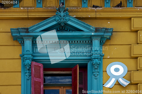 Image of  old blue yellow little terrace red venetian blind and roof 