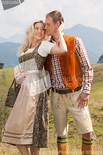 Image of Young romantic couple in traditional Bavarian costumes