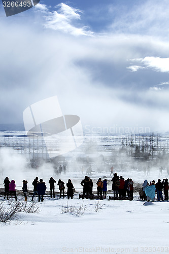 Image of Visitors watching the eruption of a geyser in Iceland