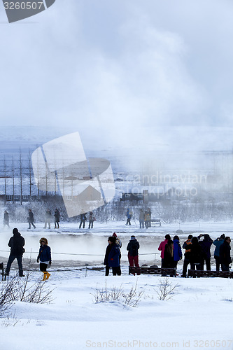 Image of Visitors watching the eruption of a geyser in Iceland