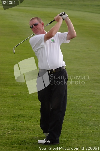 Image of Male golfer playing