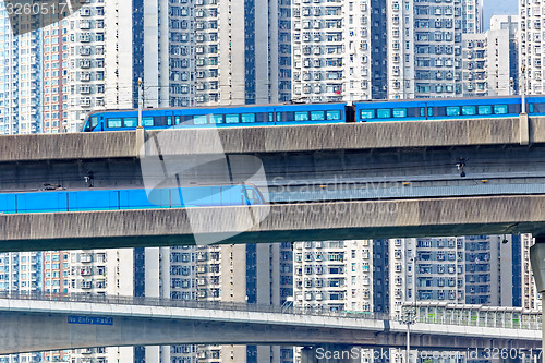 Image of high speed train on bridge in hong kong downtown city