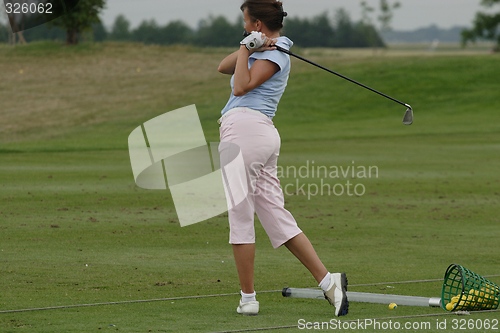 Image of Female golfer playing