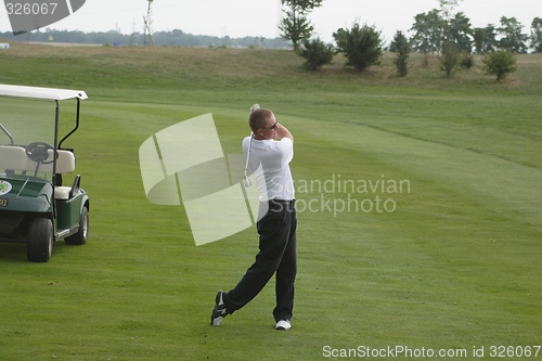 Image of Male golfer playing