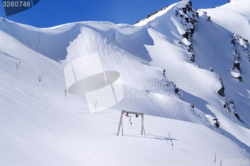 Image of Old surface lift and mountains with snow cornice