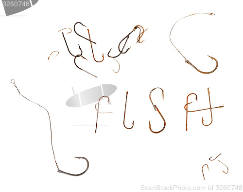 Image of Word F I S H and old rusty fish hooks