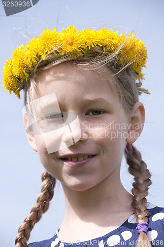 Image of young girl portrait in yellow dandelion garland