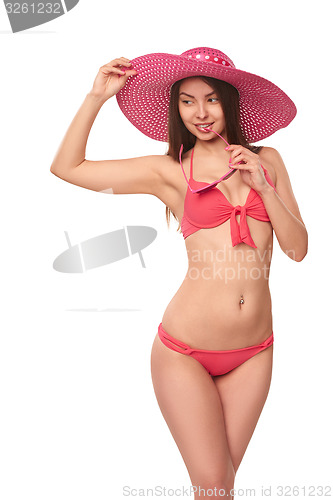 Image of Woman in pink swimsuit and hat